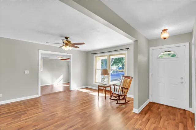 a view of a livingroom with furniture and a table chair