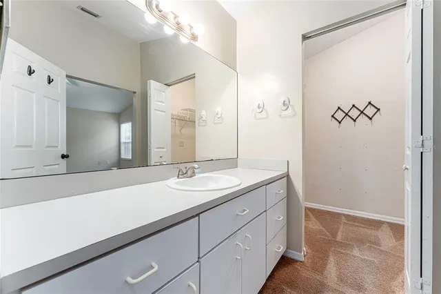 a bathroom with a double vanity sink toilet mirror and bathtub