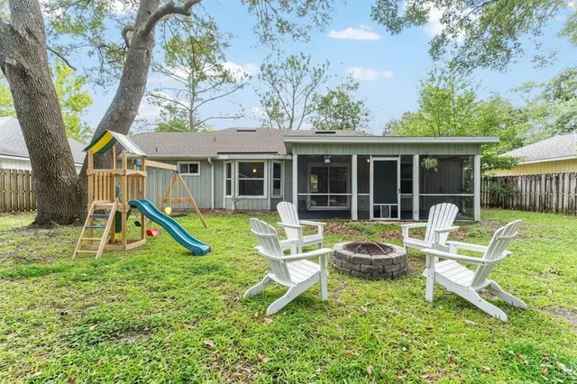a backyard of a house with large trees and brick walls