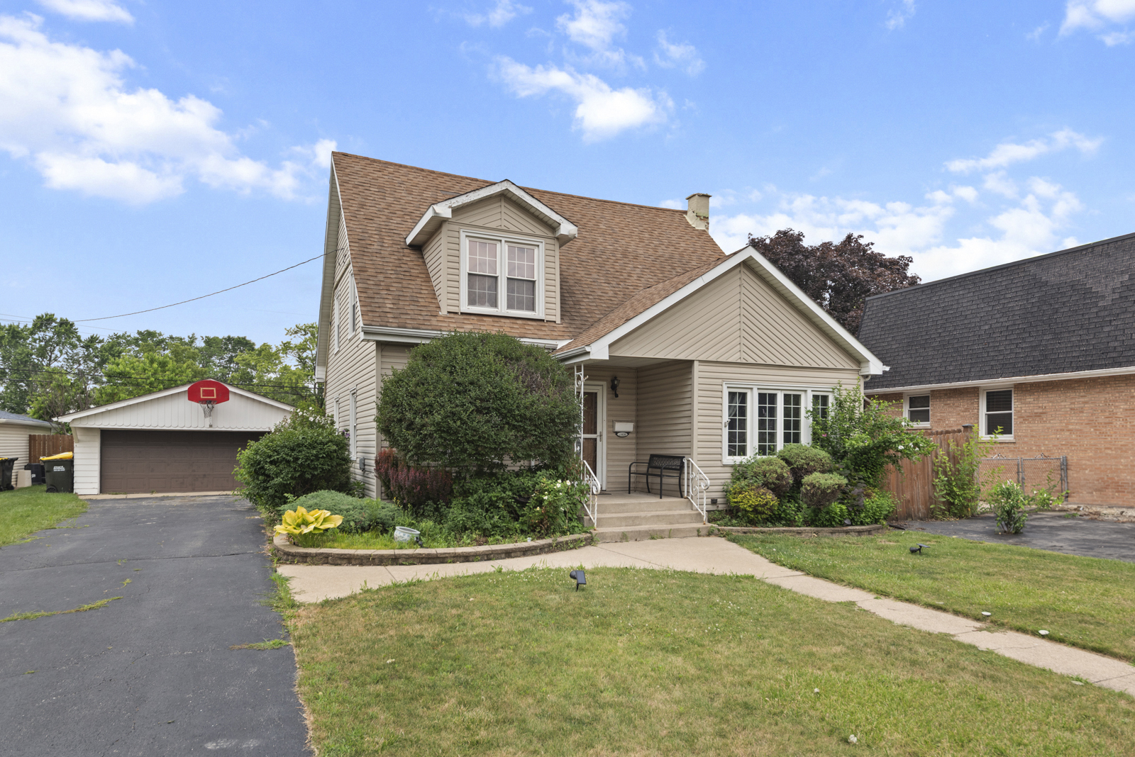 11030 Austin Avenue Chicago Ridge, IL 60415 - Photo 2 of 17 a front view of a house with a yard and garage
