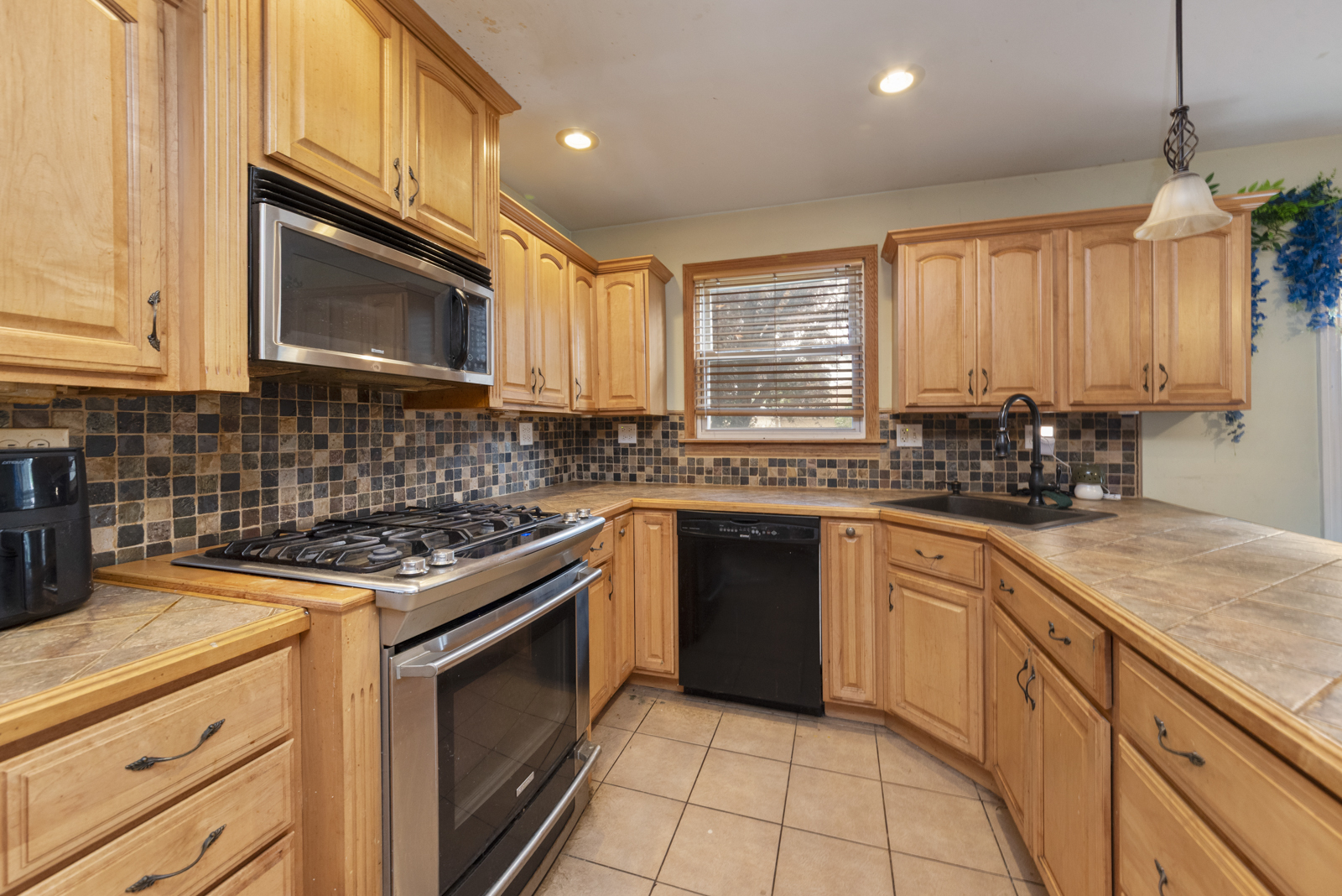 11030 Austin Avenue Chicago Ridge, IL 60415 - Photo 7 of 17 a kitchen with stainless steel appliances granite countertop a sink a stove a microwave and cabinets