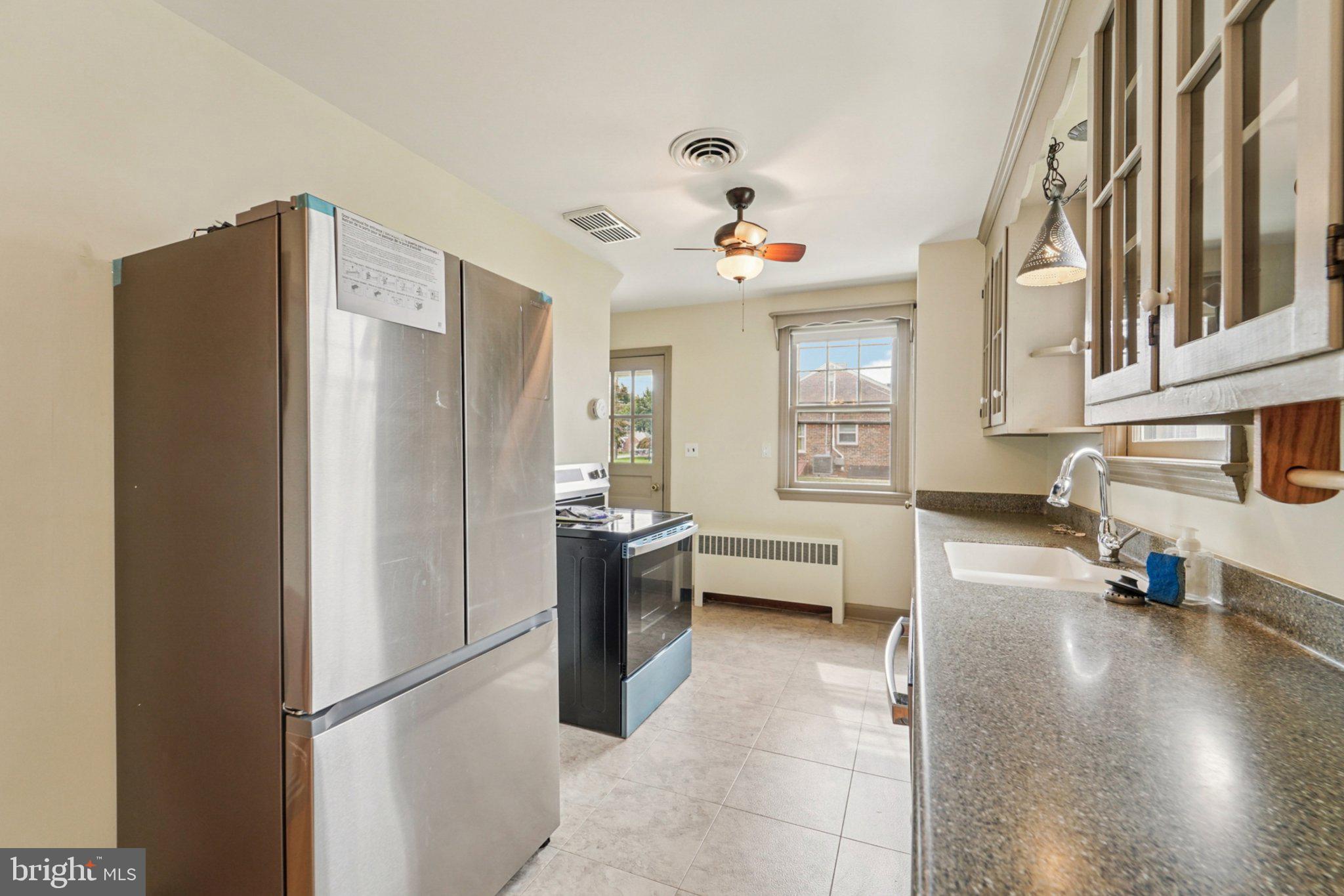 1008 North Main Street Mount Airy, MD 21771 - Photo 11 of 52 a kitchen with stainless steel appliances a refrigerator and a stove