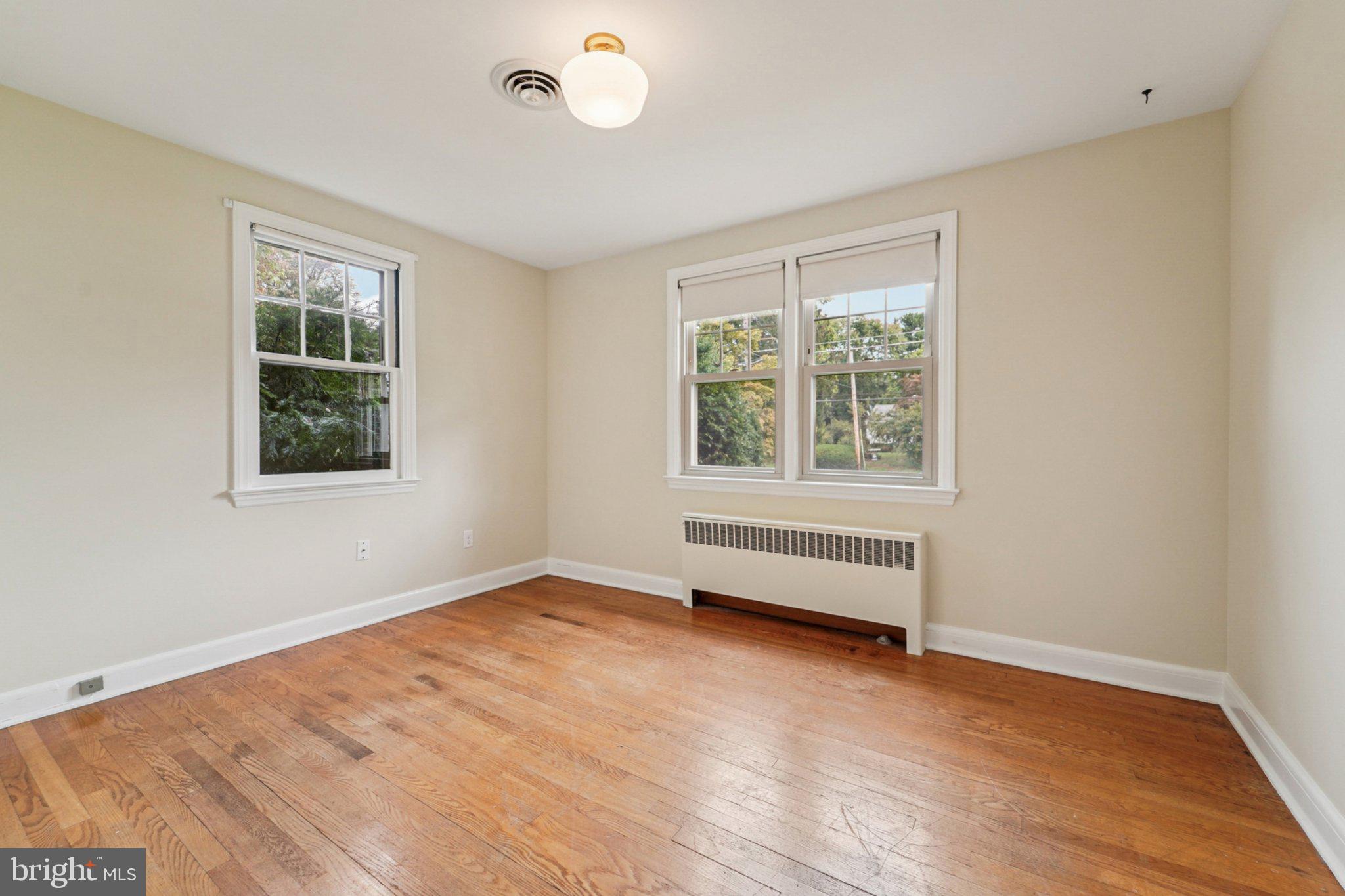 1008 North Main Street Mount Airy, MD 21771 - Photo 14 of 52 an empty room with wooden floor and windows