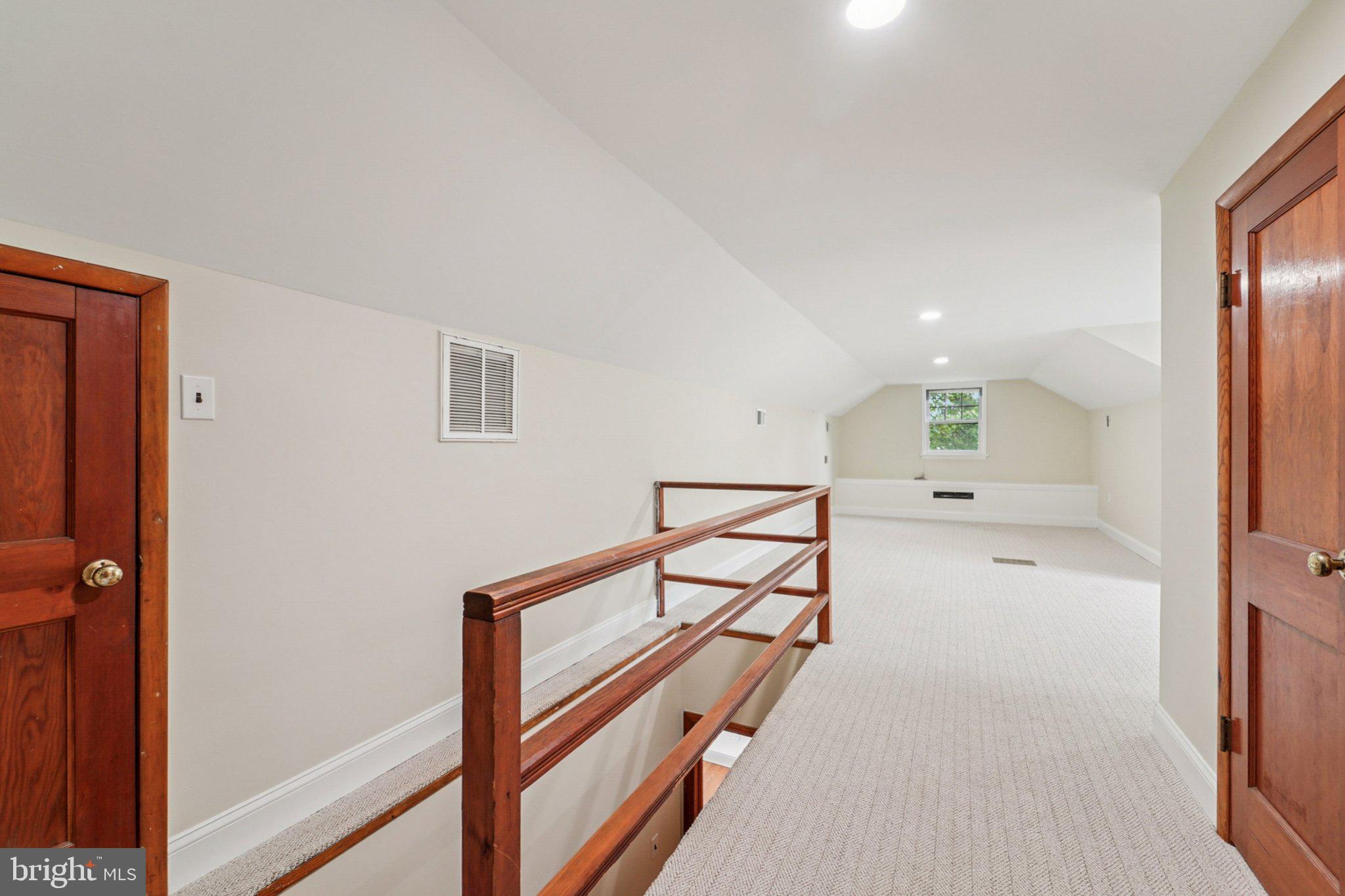 1008 North Main Street Mount Airy, MD 21771 - Photo 19 of 52 a view of a hallway to a room with wooden floor and furniture