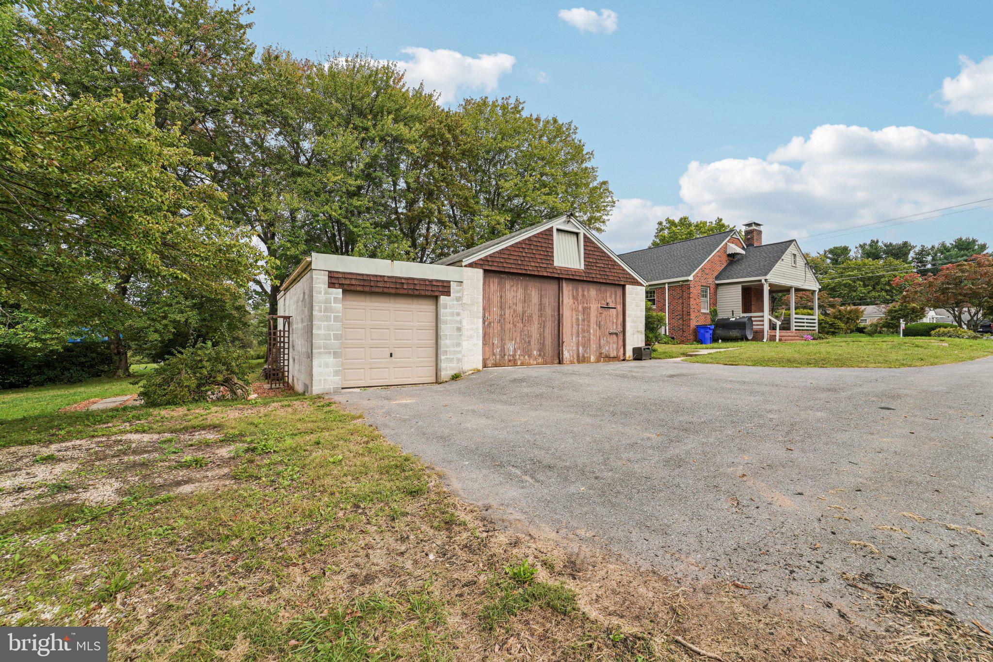 1008 North Main Street Mount Airy, MD 21771 - Photo 34 of 52 a front view of a house with a yard and garage