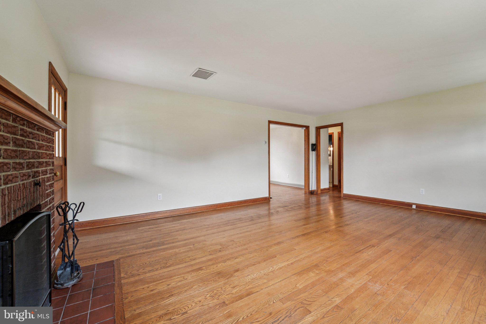 1008 North Main Street Mount Airy, MD 21771 - Photo 7 of 52 a view of an empty room with wooden floor and a window