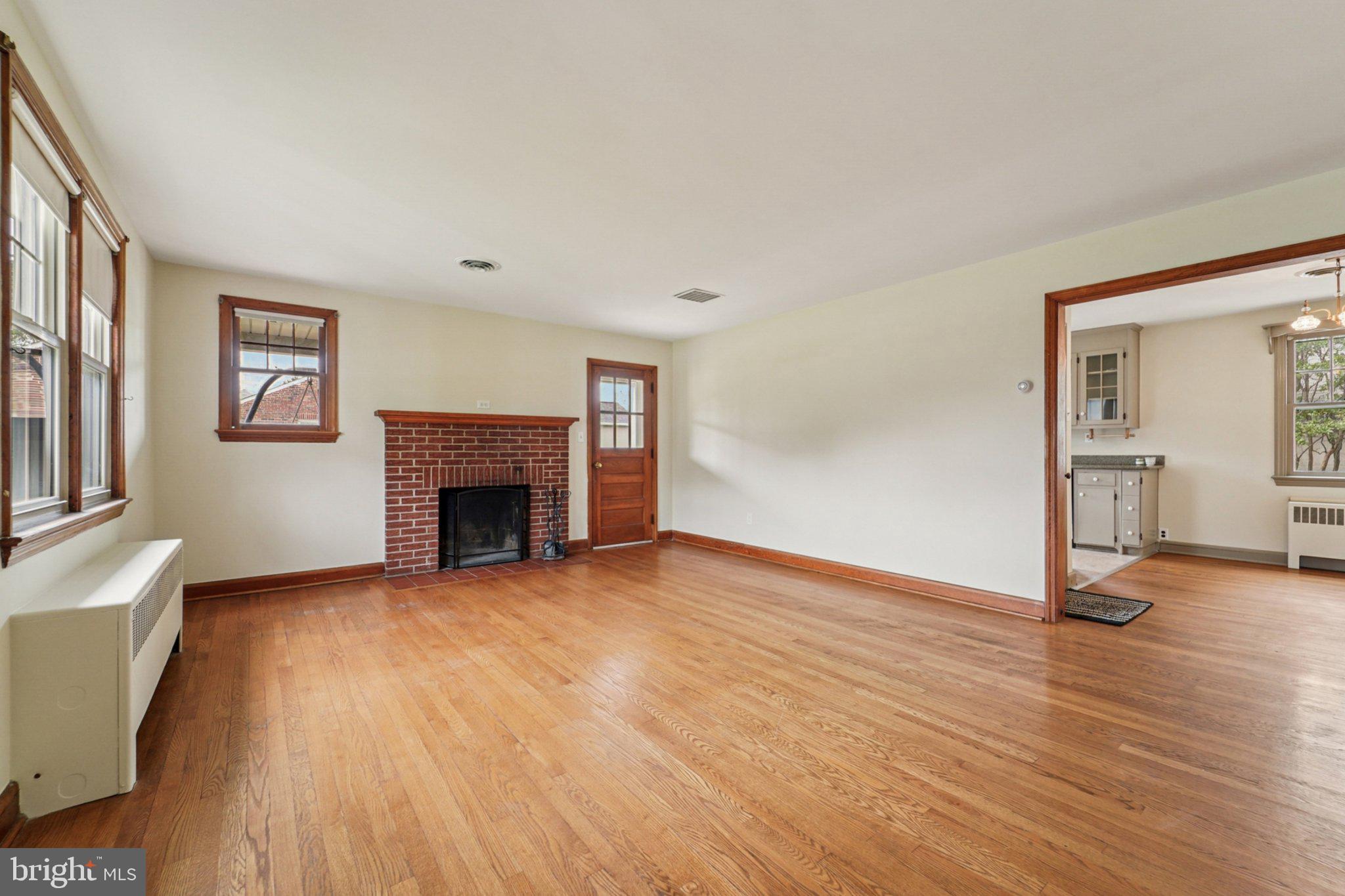 1008 North Main Street Mount Airy, MD 21771 - Photo 8 of 52 a view of an empty room with wooden floor and a fireplace