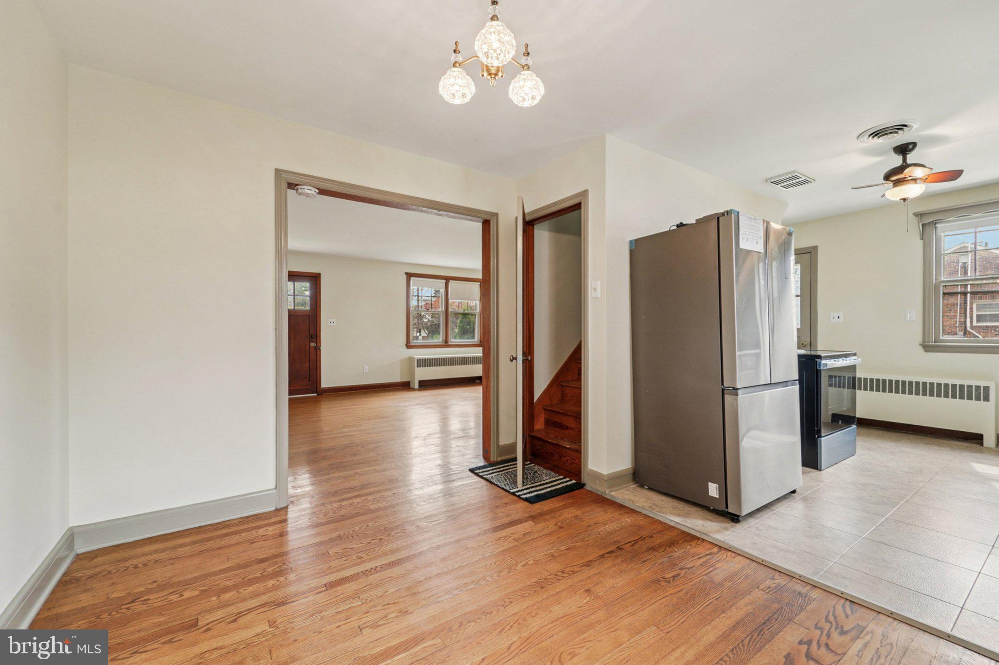 1008 North Main Street Mount Airy, MD 21771 - Photo 10 of 52 a view of a livingroom with wooden floor and a kitchen space
