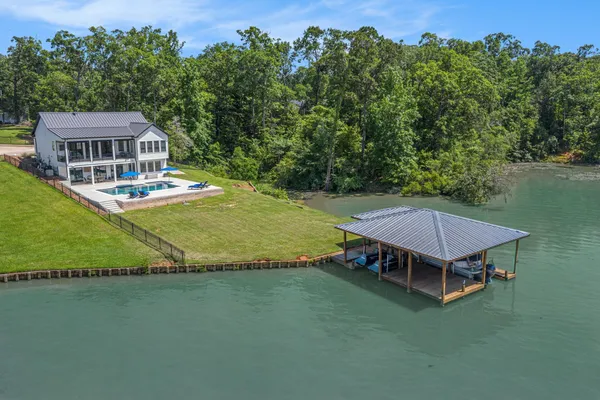 an aerial view of a house with swimming pool garden and outdoor seating
