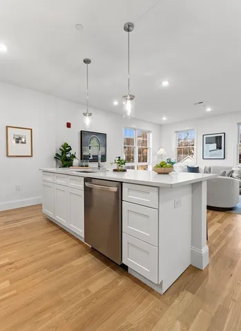 a kitchen with counter top space cabinets and appliances