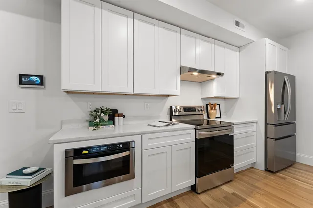 a kitchen with a stove and a refrigerator
