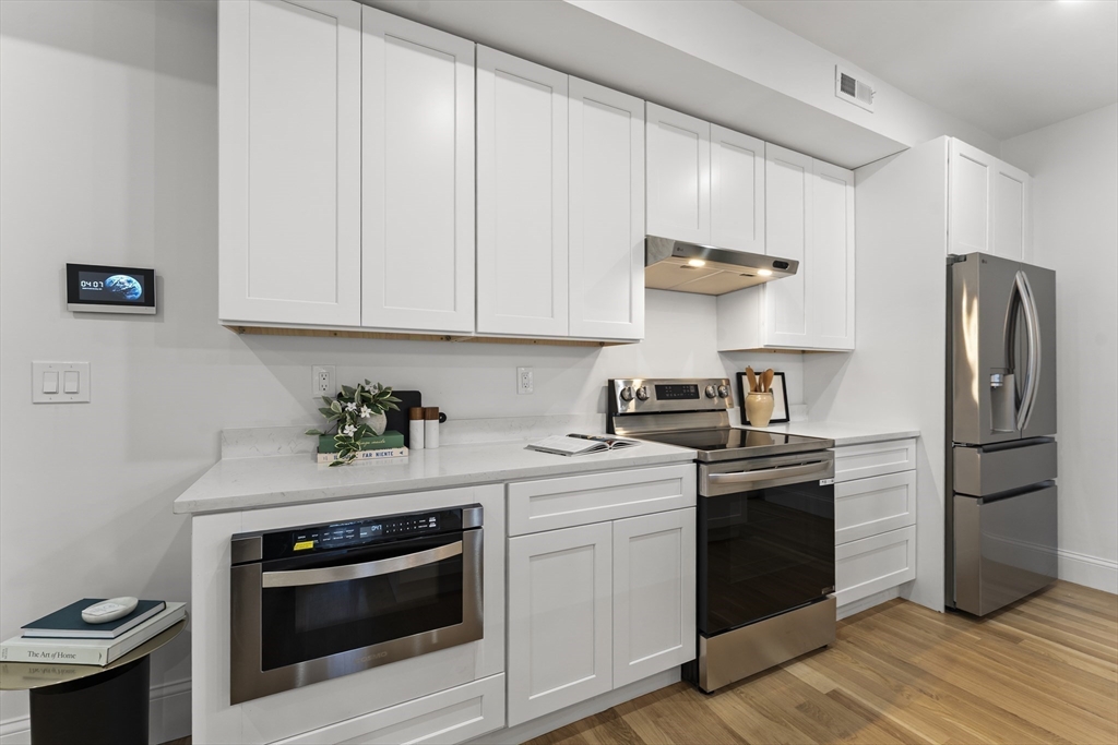 272 Lincoln Street, Unit 301 Marlborough, MA 01752 - Photo 12 of 30 a kitchen with a stove and a refrigerator