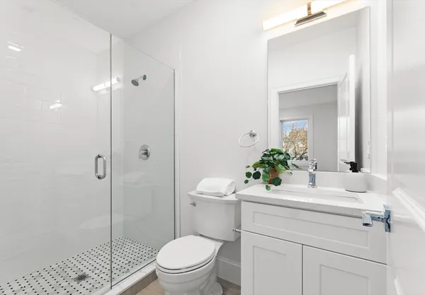 a bathroom with a sink toilet and shower