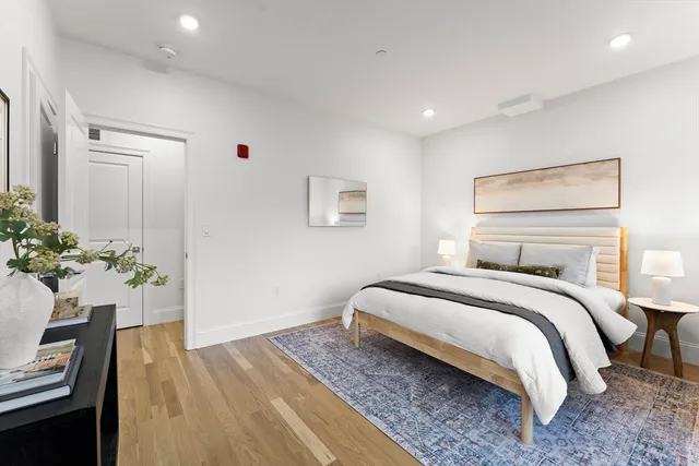 a bedroom with a bed and a potted plant