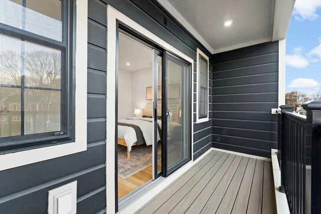 a view of a hallway with wooden floor and furniture