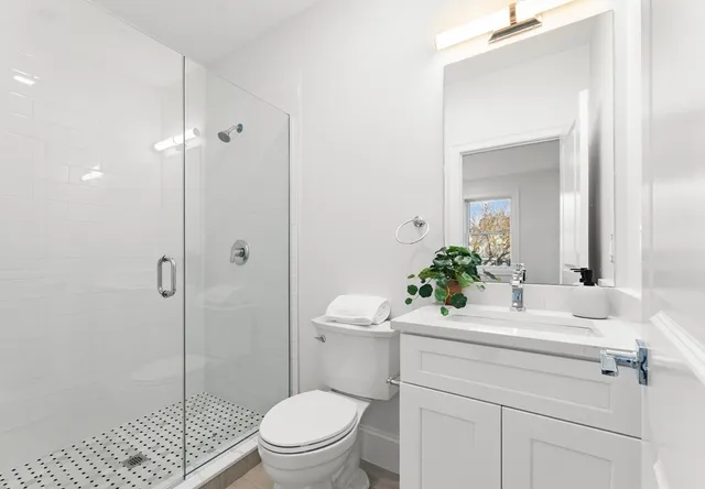 a bathroom with a sink toilet and shower