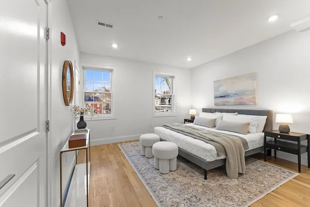 a bedroom with a bed and a couch