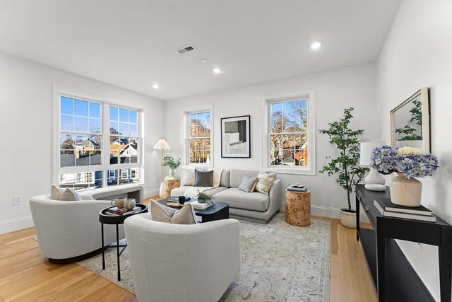 a living room with furniture and flowers
