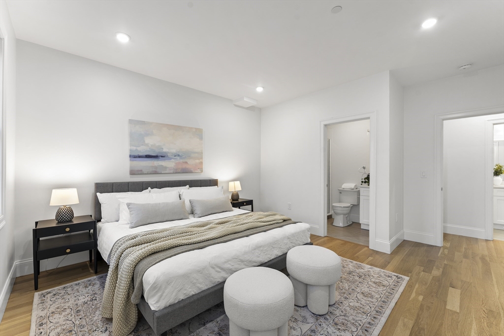 272 Lincoln Street, Unit 301 Marlborough, MA 01752 - Photo 21 of 30 a bedroom with a bed and wooden floor