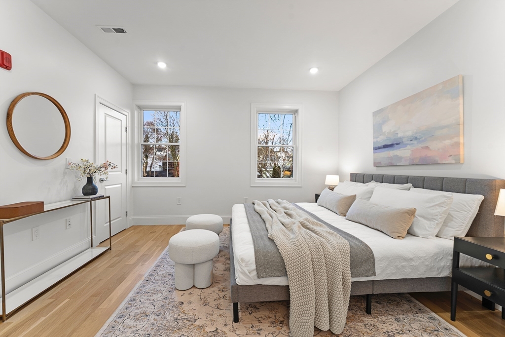 272 Lincoln Street, Unit 301 Marlborough, MA 01752 - Photo 22 of 30 a bed room with a bed and painting on the wall