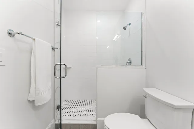 a bathroom with a toilet sink and shower