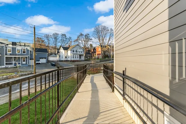 a view of a balcony with wooden floor and staircase