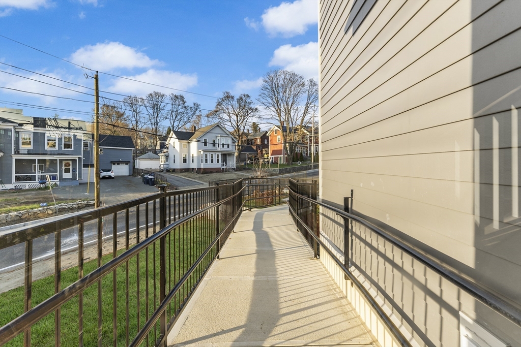 272 Lincoln Street, Unit 301 Marlborough, MA 01752 - Photo 30 of 30 a view of a balcony with wooden floor and staircase