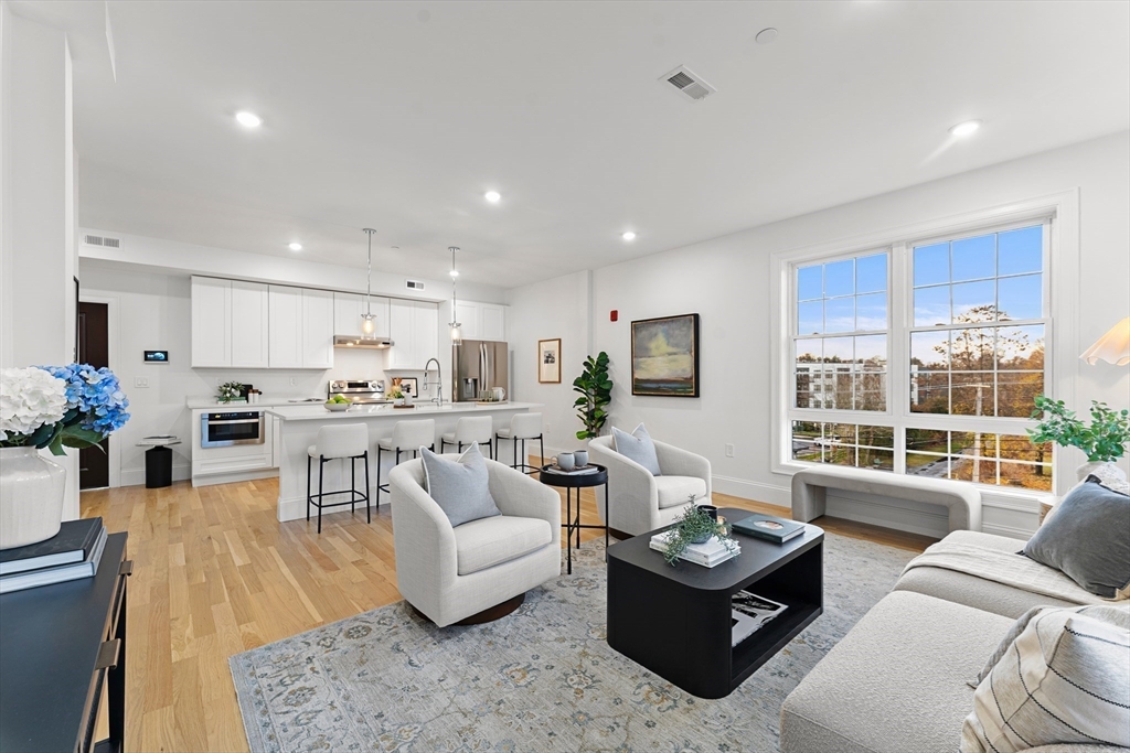 272 Lincoln Street, Unit 301 Marlborough, MA 01752 - Photo 6 of 30 a living room with furniture and a large window