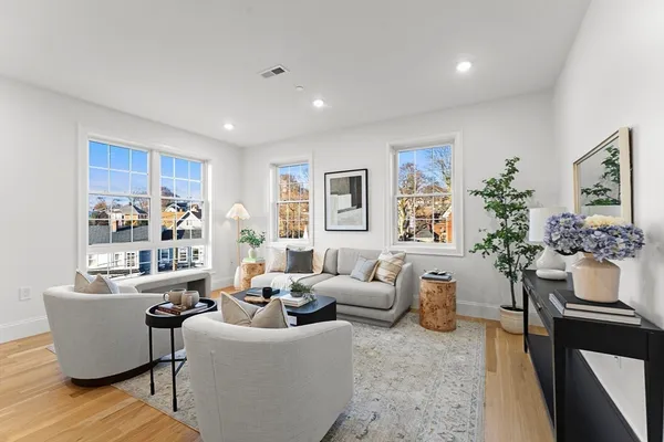 a living room with furniture and flowers