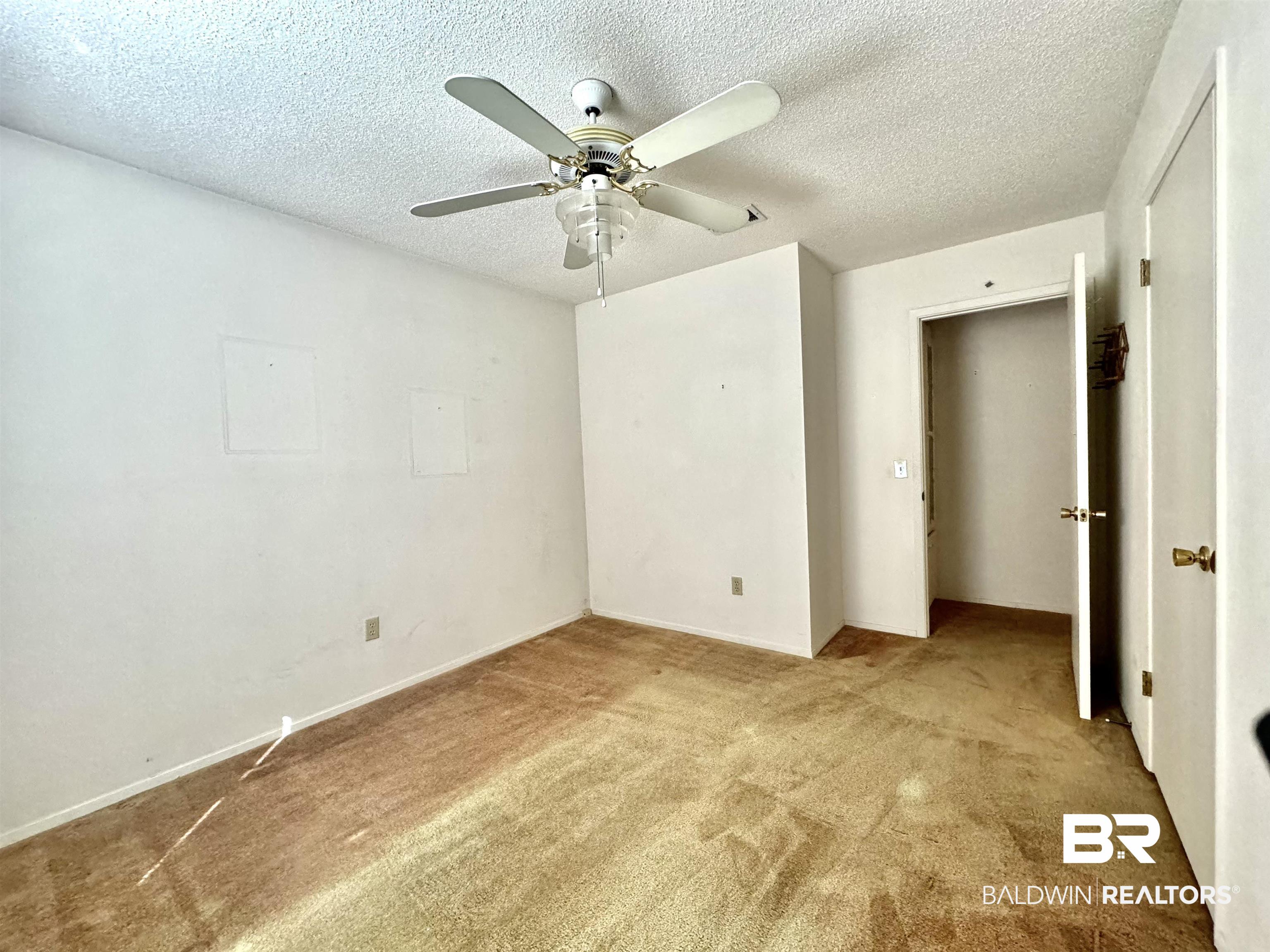 512 Deborah Court Foley, AL 36535 - Photo 17 of 23 Carpeted empty room with a textured ceiling and ceiling fan
