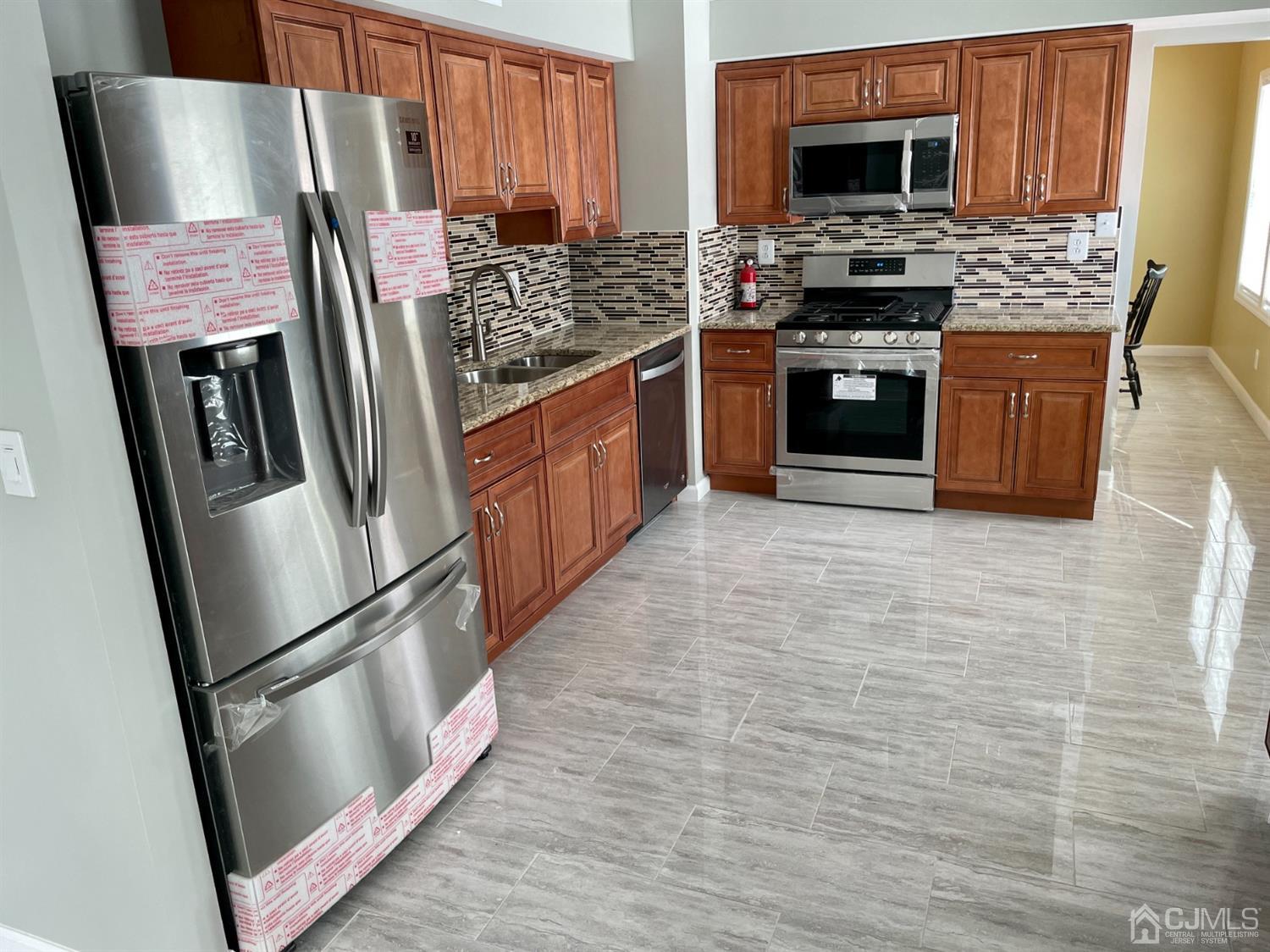 43 Hunt Road Somerset, NJ 08873 - Photo 8 of 21 a kitchen with stainless steel appliances granite countertop a refrigerator stove and sink