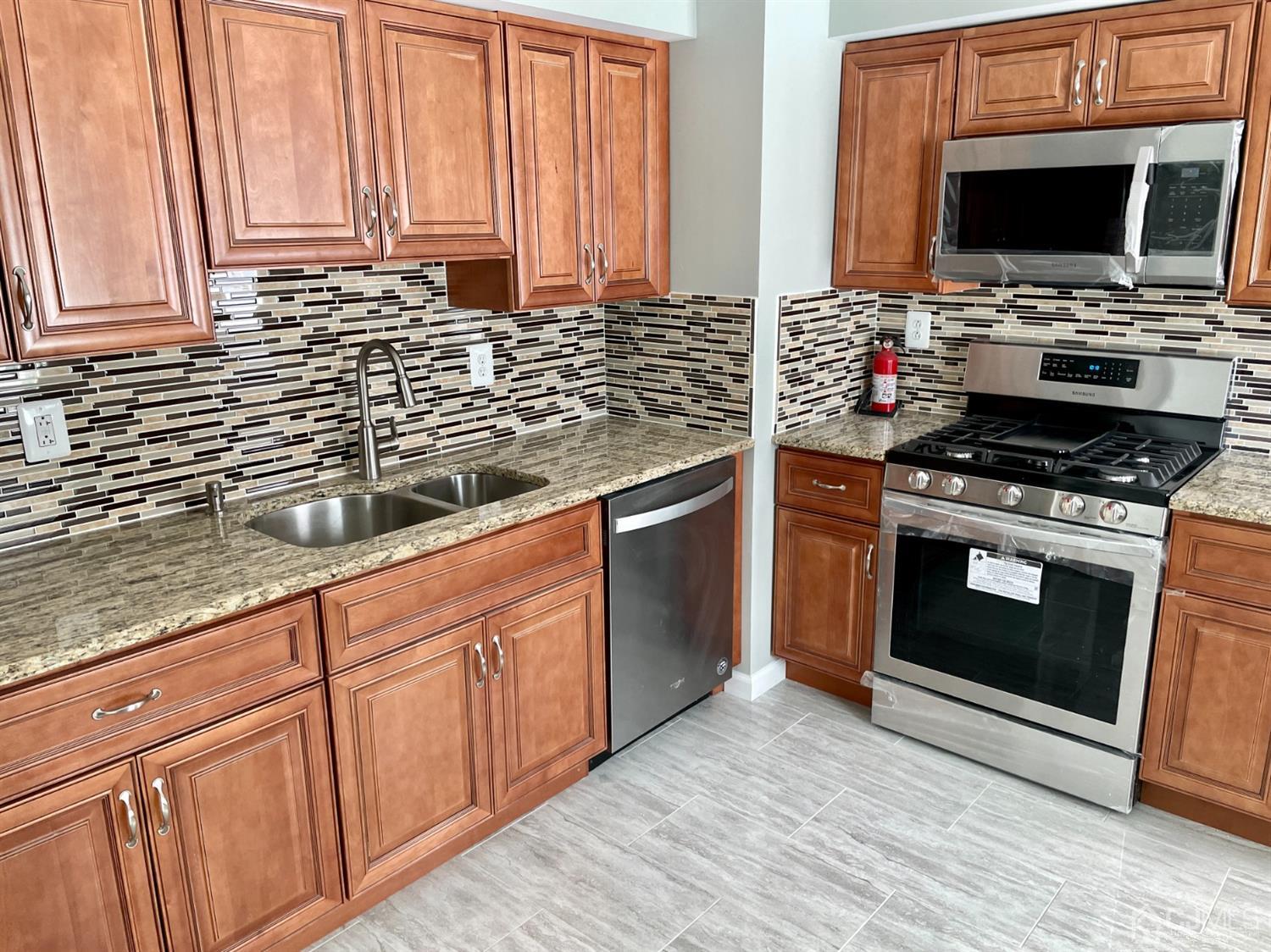 43 Hunt Road Somerset, NJ 08873 - Photo 9 of 21 a kitchen with stainless steel appliances a stove a sink and a microwave