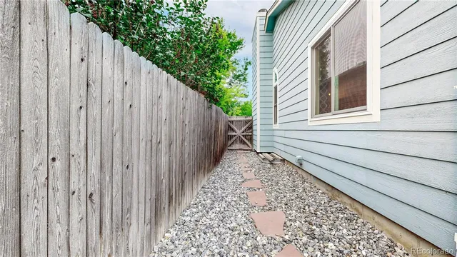 a view of a house with a wooden fence
