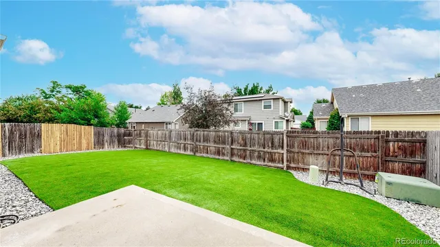 a view of a garden with a wooden fence