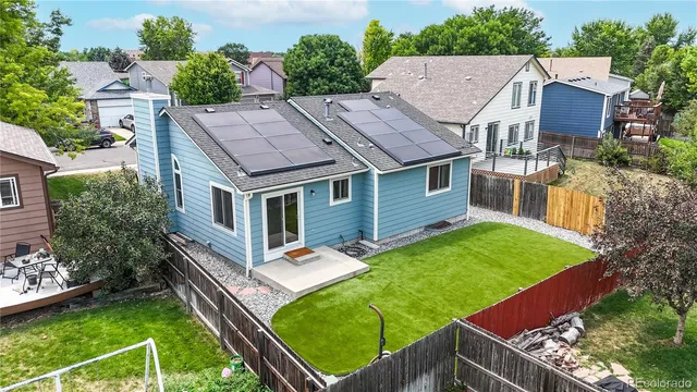 an aerial view of a house with swimming pool garden and patio