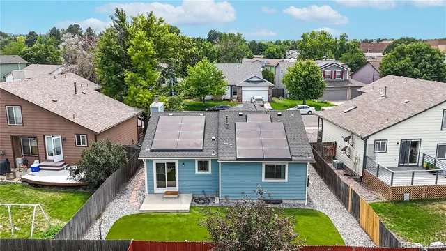 an aerial view of a house with swimming pool garden and patio