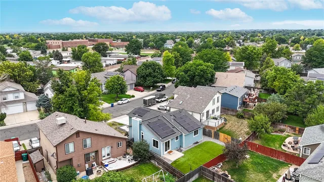an aerial view of multiple houses with yard