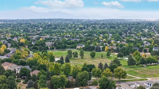 an aerial view of residential houses with outdoor space and lake view