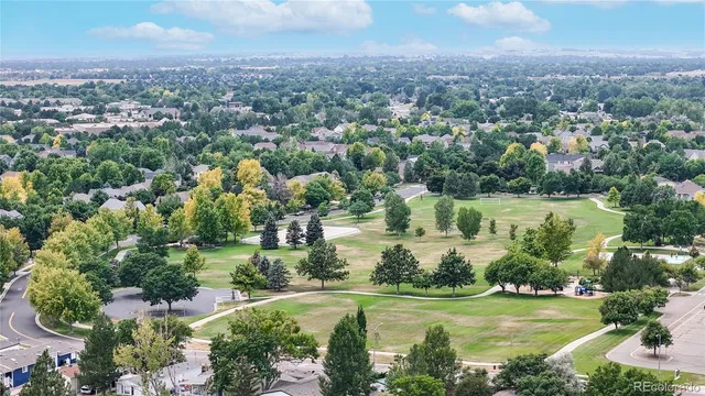 an aerial view of residential houses with outdoor space and lake view