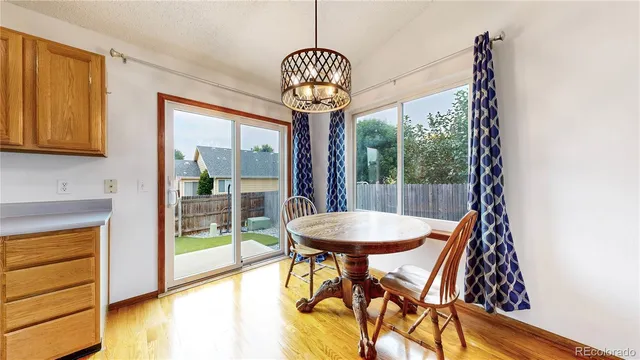 a view of a dining room with furniture wooden floor and a chandelier