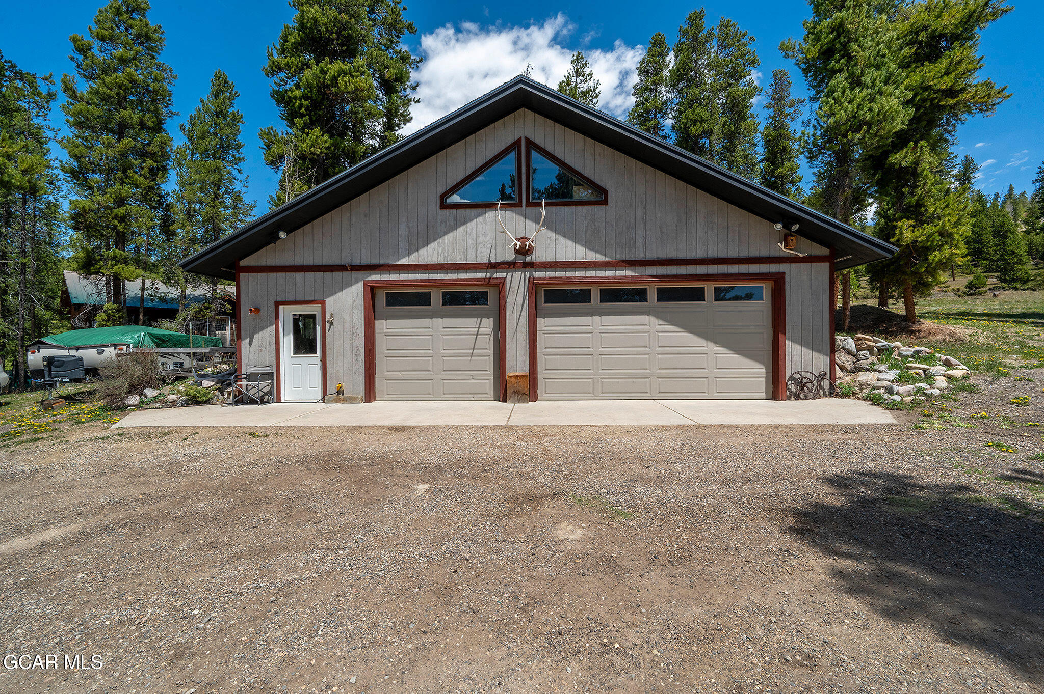 732 Gcr 8311/ Clayton Ranch Road Tabernash, CO 80478 - Photo 57 of 65 a front view of a house with a yard and garage