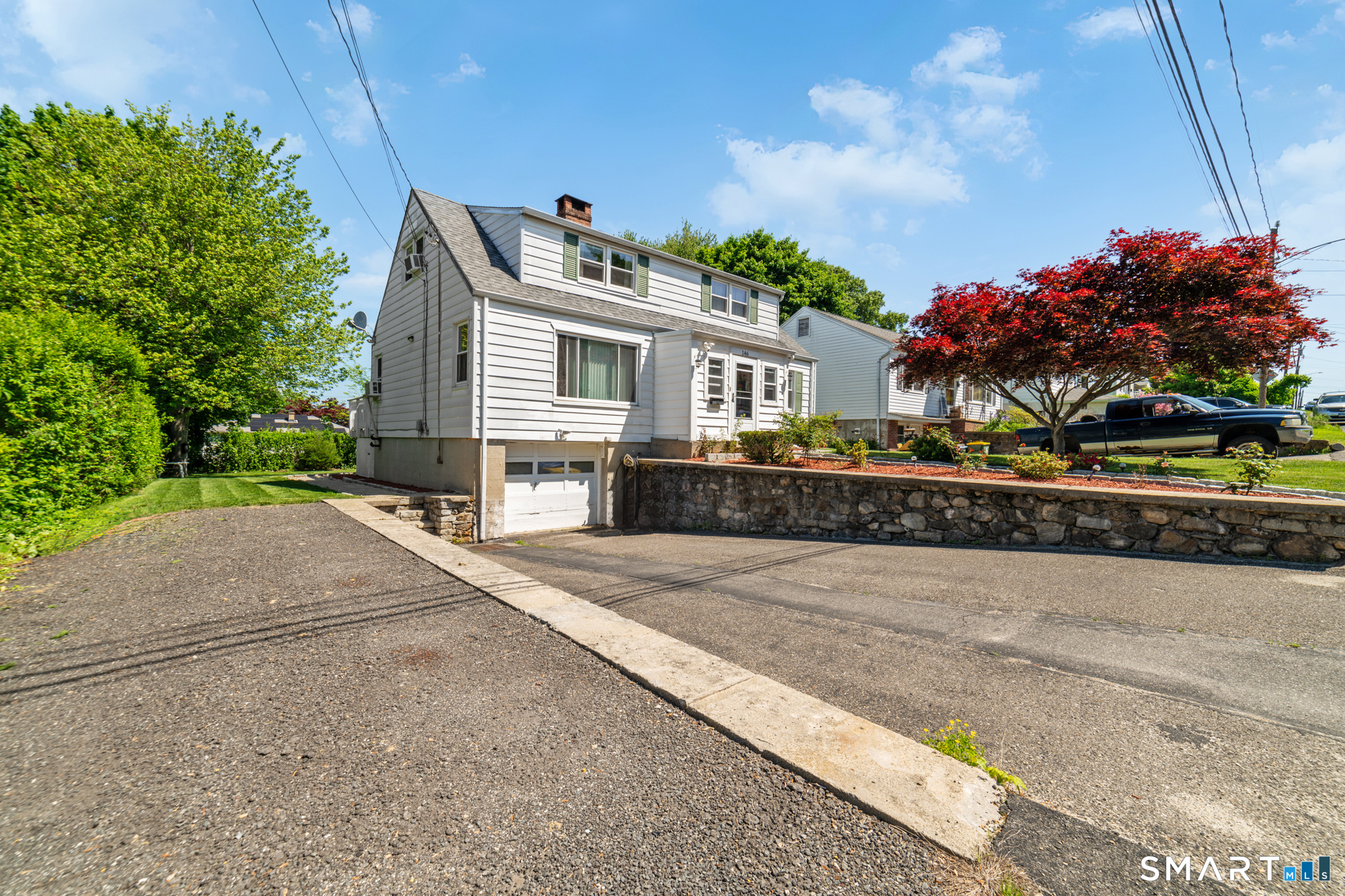 146 Highland Drive Waterbury, CT 06708 - Photo 30 of 31 a front view of a house with a yard and a garage