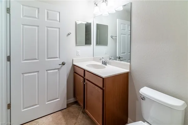 a bathroom with a sink vanity and a toilet