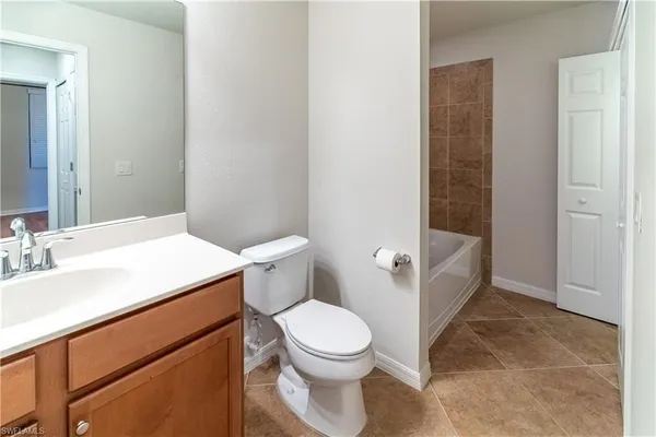 a white toilet sitting next to a bathroom sink