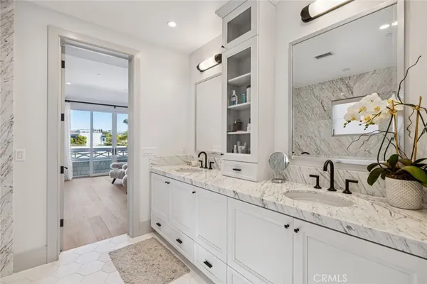 a bathroom with double vanity sink and mirror