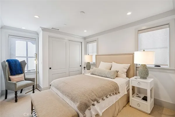 a bedroom with a bed and a chair