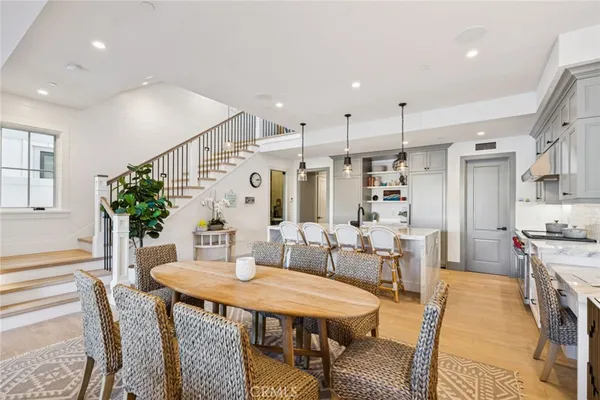 a dining room with furniture a rug and wooden floor