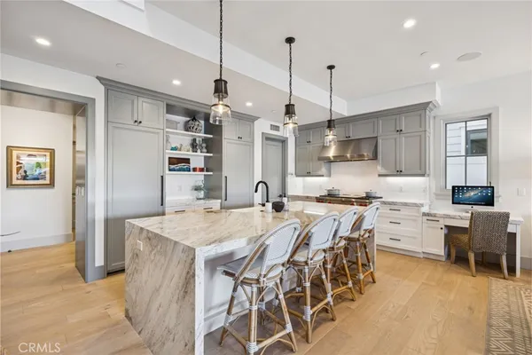 a large kitchen with a table and chairs