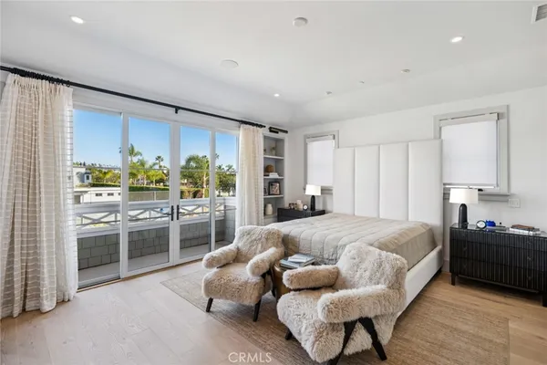 a spacious bedroom with a bed and glass window