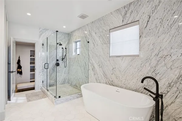 a bathroom with a tub and shower